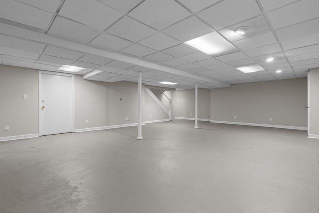 basement with a paneled ceiling