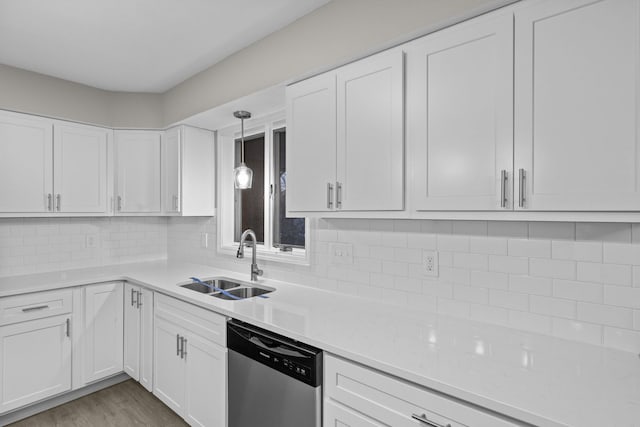 kitchen featuring tasteful backsplash, sink, white cabinets, and dishwasher