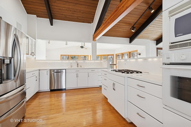 kitchen featuring ceiling fan, light countertops, wood ceiling, and stainless steel appliances