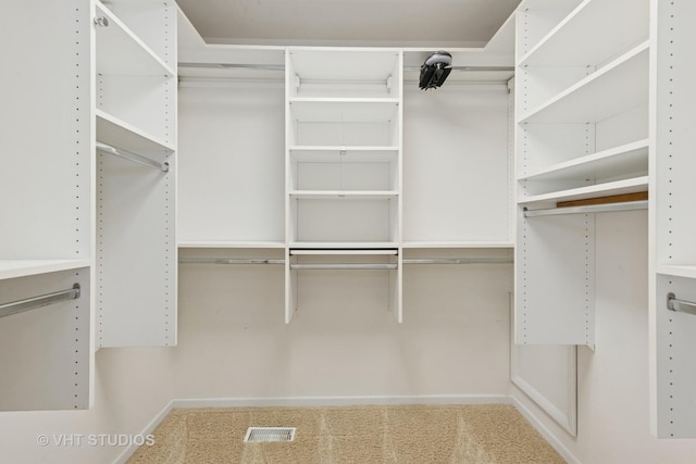 spacious closet with visible vents and carpet