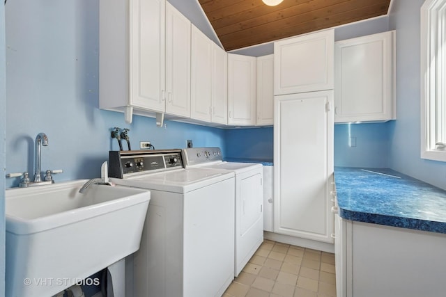 clothes washing area featuring a sink, cabinet space, independent washer and dryer, and wooden ceiling