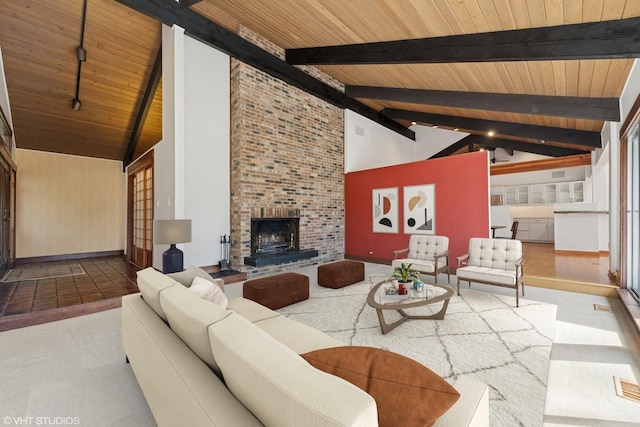 carpeted living area featuring beamed ceiling, baseboards, wooden ceiling, and a fireplace