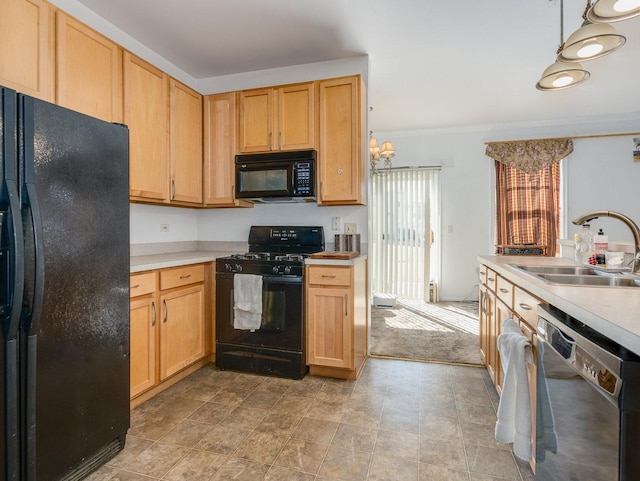 kitchen featuring black appliances, crown molding, light countertops, and a sink