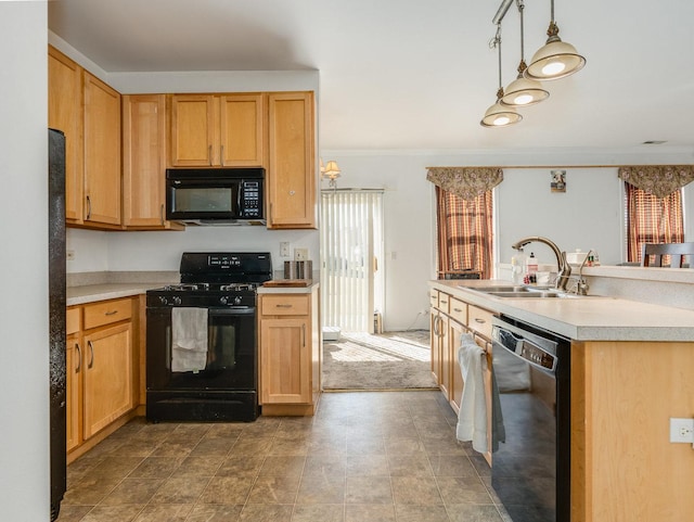 kitchen with black appliances, ornamental molding, light countertops, and a sink