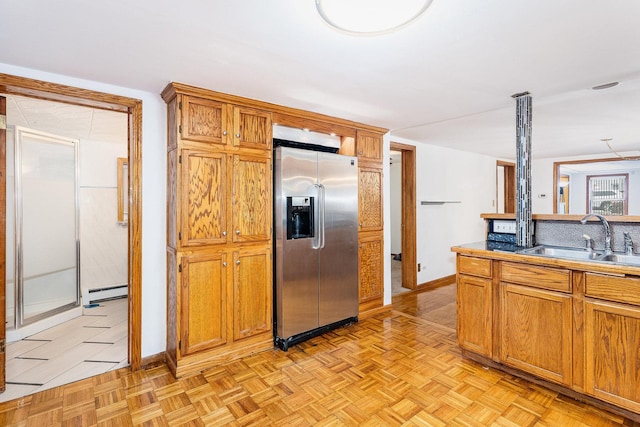 kitchen featuring sink, a baseboard radiator, light parquet floors, and stainless steel refrigerator with ice dispenser