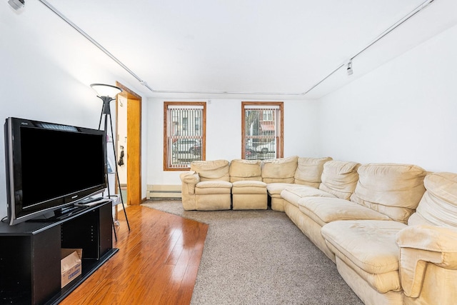 living room featuring a baseboard radiator, rail lighting, and hardwood / wood-style floors