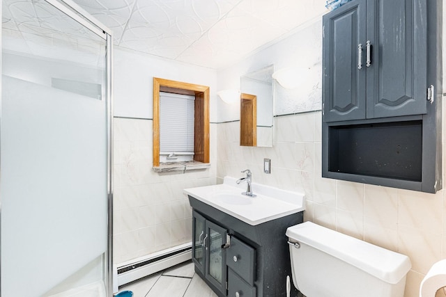 bathroom with tile walls, a baseboard heating unit, vanity, toilet, and walk in shower