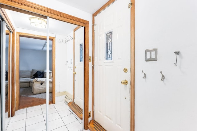 doorway with a baseboard heating unit and light tile patterned floors