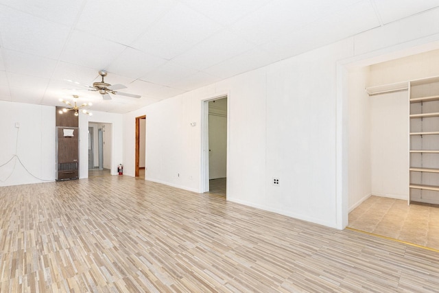 empty room featuring ceiling fan and light hardwood / wood-style floors