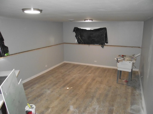 interior space with baseboards and wood finished floors