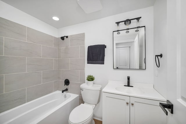 full bathroom with vanity, tiled shower / bath combo, and toilet