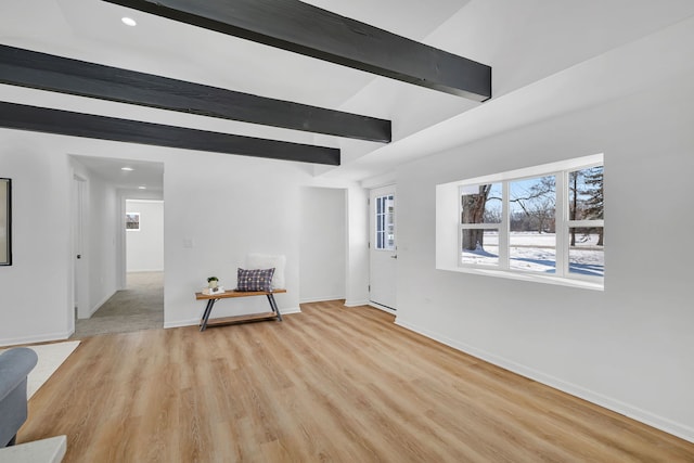 foyer with beam ceiling and light hardwood / wood-style floors