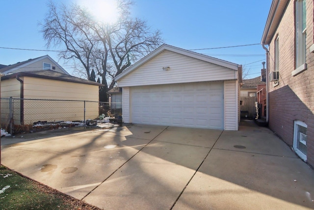 detached garage featuring fence