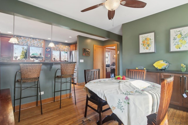 dining room featuring a ceiling fan, light wood-type flooring, baseboards, and recessed lighting