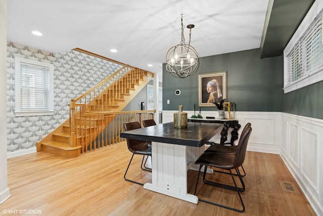 dining space featuring visible vents, wainscoting, light wood-style flooring, stairway, and recessed lighting