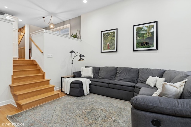 living area with baseboards, stairway, wood finished floors, and recessed lighting