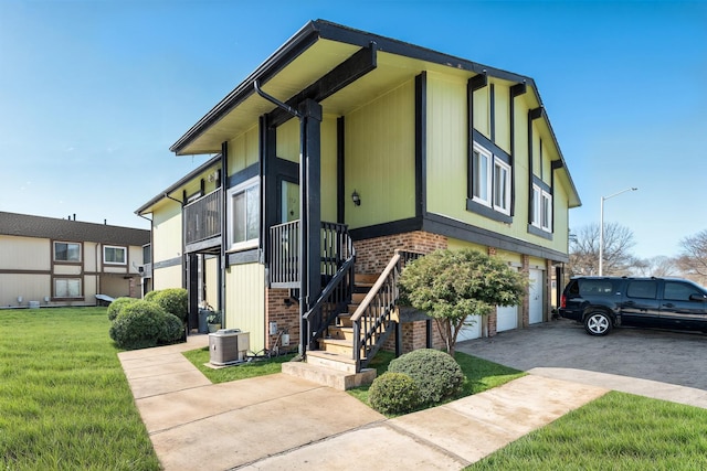 view of front facade featuring central AC unit, a garage, and a front yard