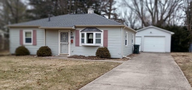 view of front facade with an outbuilding, a garage, and a front yard