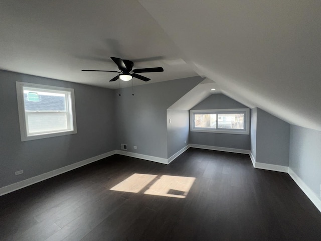 bonus room featuring dark hardwood / wood-style flooring, lofted ceiling, and ceiling fan