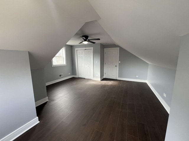 additional living space featuring dark wood-type flooring, ceiling fan, and vaulted ceiling