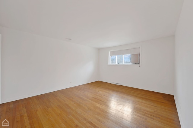 spare room featuring hardwood / wood-style floors