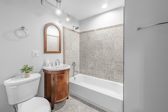 full bathroom with tiled shower / bath combo, vanity, and toilet