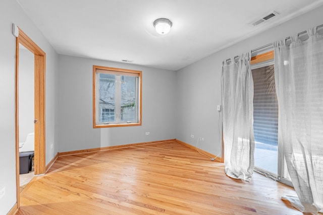 unfurnished bedroom with access to outside and light wood-type flooring