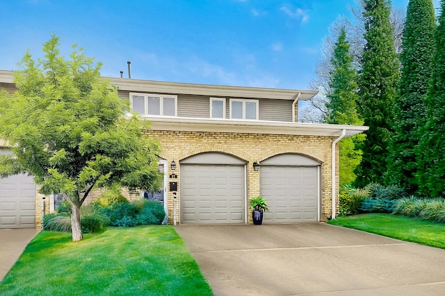 view of front of property featuring a garage, concrete driveway, and brick siding