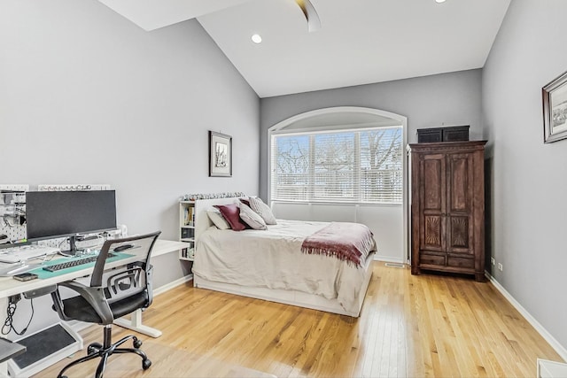 bedroom featuring baseboards, visible vents, a ceiling fan, lofted ceiling, and light wood-type flooring