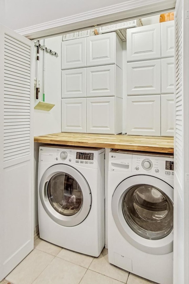 laundry room featuring laundry area, light tile patterned floors, and independent washer and dryer