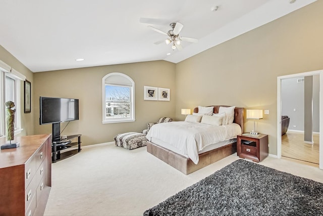 bedroom with light carpet, lofted ceiling, a ceiling fan, and baseboards