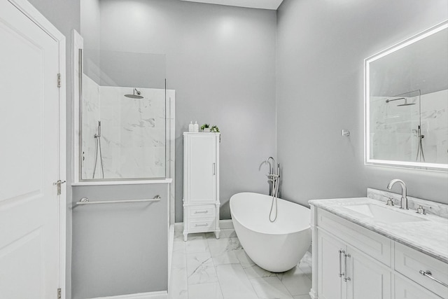 bathroom with marble finish floor, a marble finish shower, a freestanding bath, and vanity