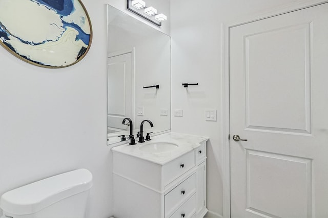 bathroom with toilet and vanity