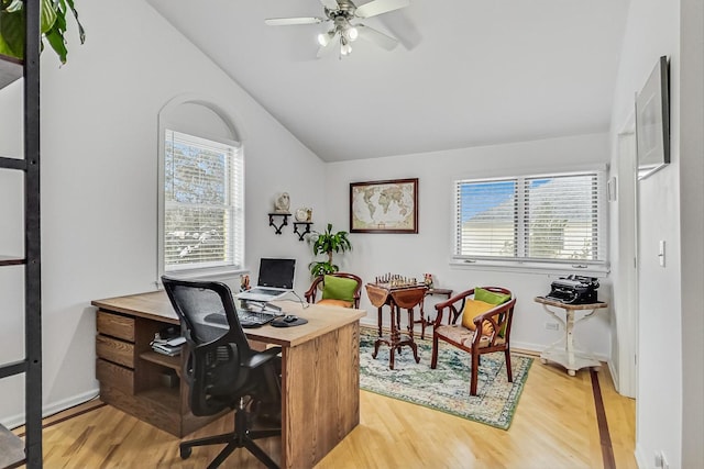 office featuring lofted ceiling, plenty of natural light, a ceiling fan, and wood finished floors