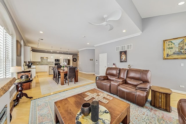 living area featuring baseboards, ornamental molding, recessed lighting, and light wood-style floors