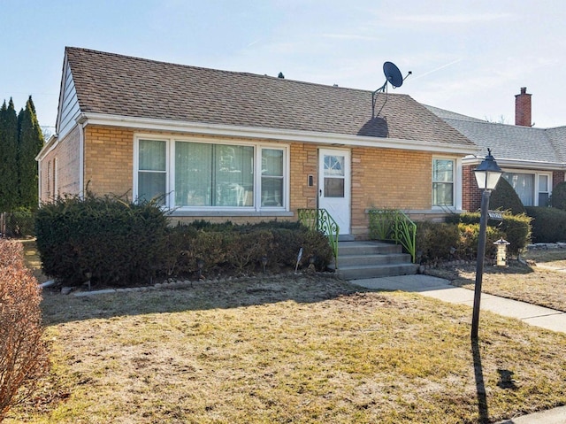 single story home with brick siding and roof with shingles