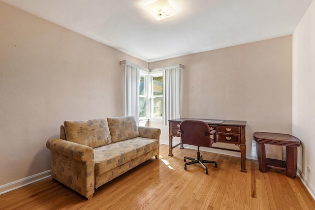 office area featuring light wood-style flooring and baseboards