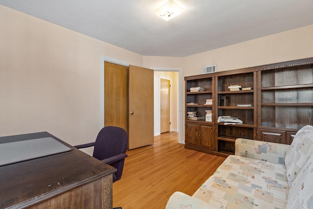 office space featuring visible vents and light wood-type flooring