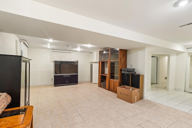 interior space with light tile patterned floors, visible vents, and baseboards