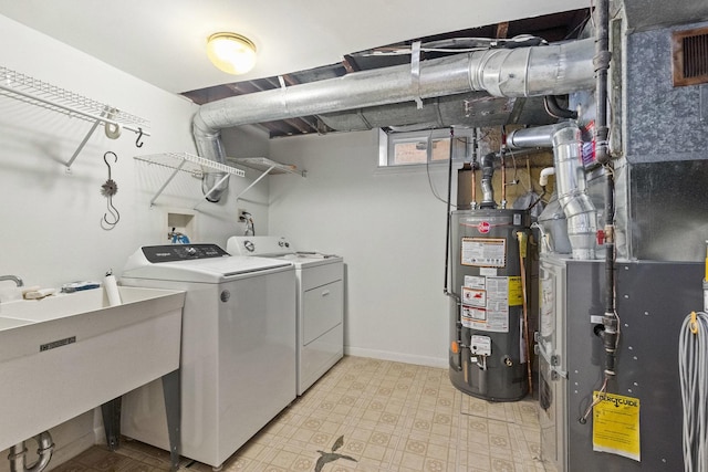 clothes washing area with heating unit, light floors, separate washer and dryer, a sink, and gas water heater