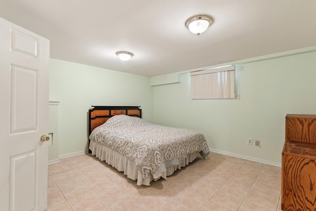 bedroom featuring light tile patterned flooring and baseboards