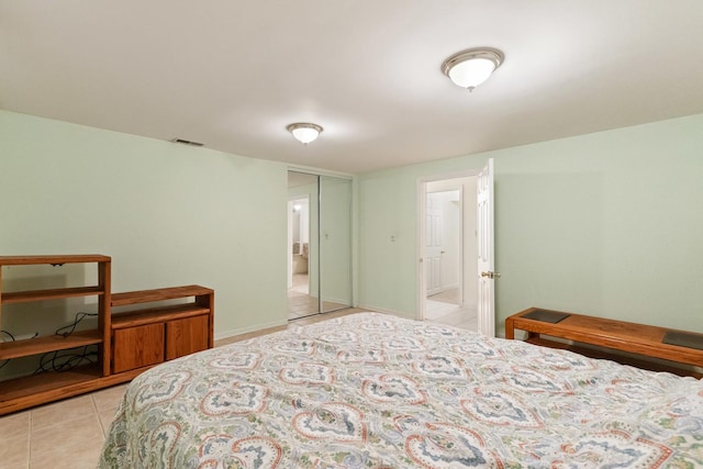 bedroom with light tile patterned floors and visible vents