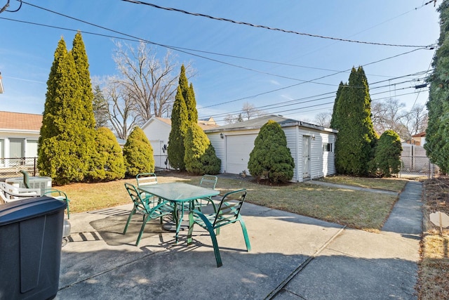 view of patio / terrace with an outdoor structure, outdoor dining space, and fence