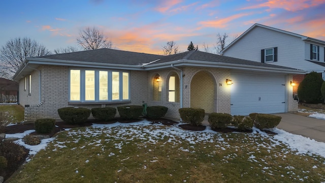 view of front of property with a garage, brick siding, and driveway