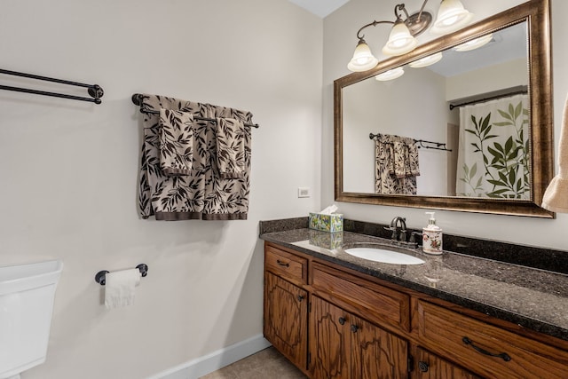 full bathroom featuring toilet, tile patterned floors, baseboards, and vanity