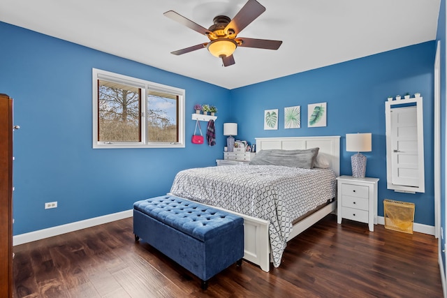 bedroom with a ceiling fan, baseboards, and wood finished floors