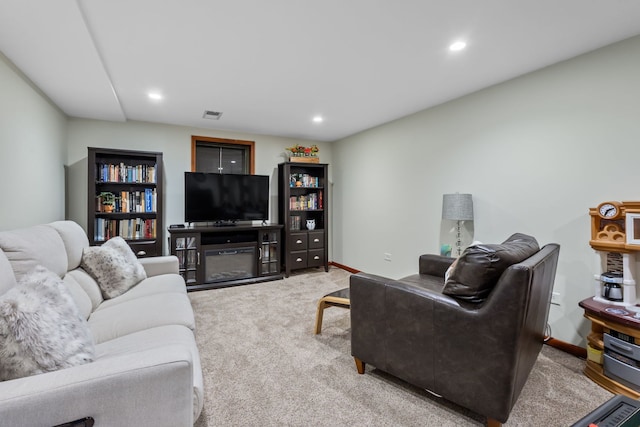 living room with recessed lighting, light carpet, visible vents, and baseboards