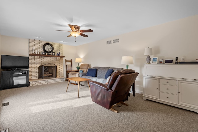 carpeted living area with a fireplace, visible vents, and a ceiling fan