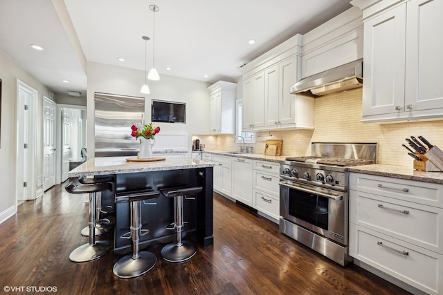 kitchen featuring a kitchen island, white cabinetry, and high end appliances