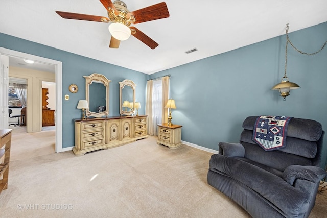 living area featuring visible vents, ceiling fan, baseboards, and carpet